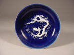 Zhengde mark & period saucer dish covered in a deep blue glaze with applied carved dragons reserved in white biscuit